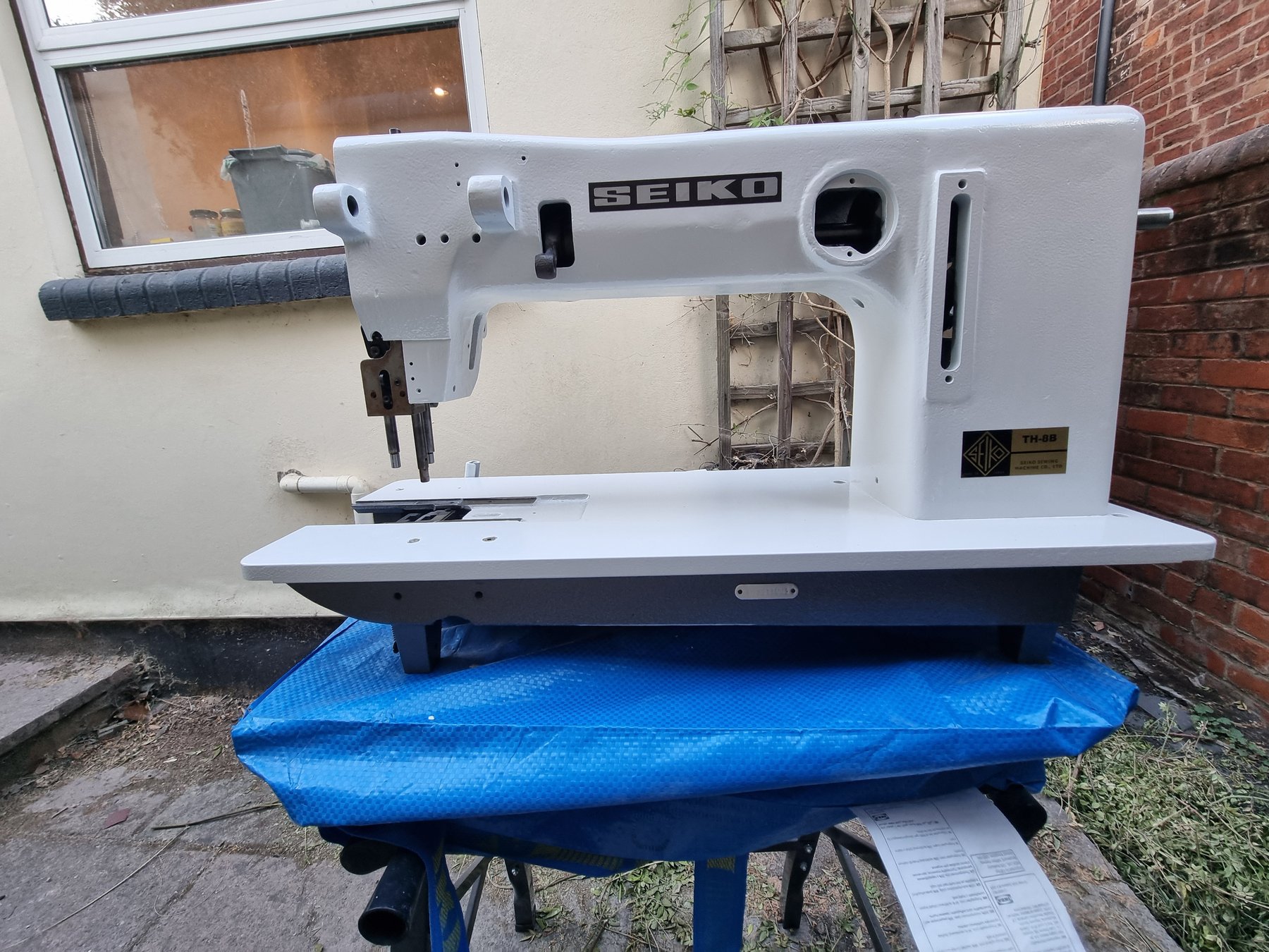 Seiko TH-8B after respray in white and grey on a blue tarp
