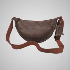 Front view of Lumengin Half Moon cross-body bag in brown hand tipped distressed leather with rust webbing strap, on soft grey