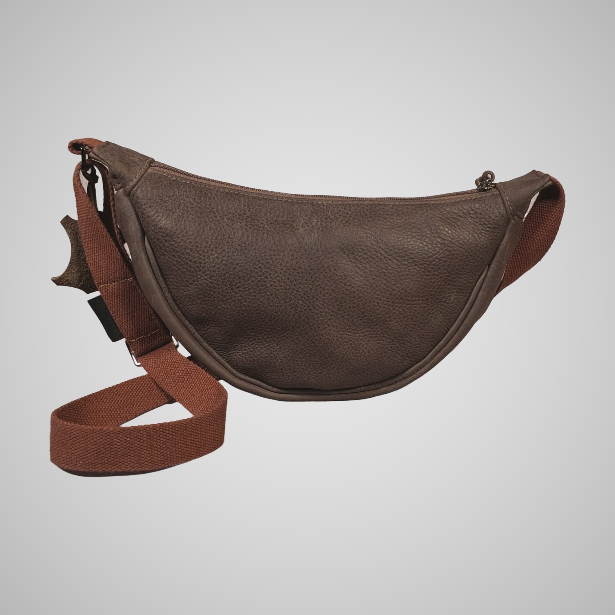 Back view of Lumengin Half Moon cross-body bag in brown hand tipped distressed leather showing curved zip top