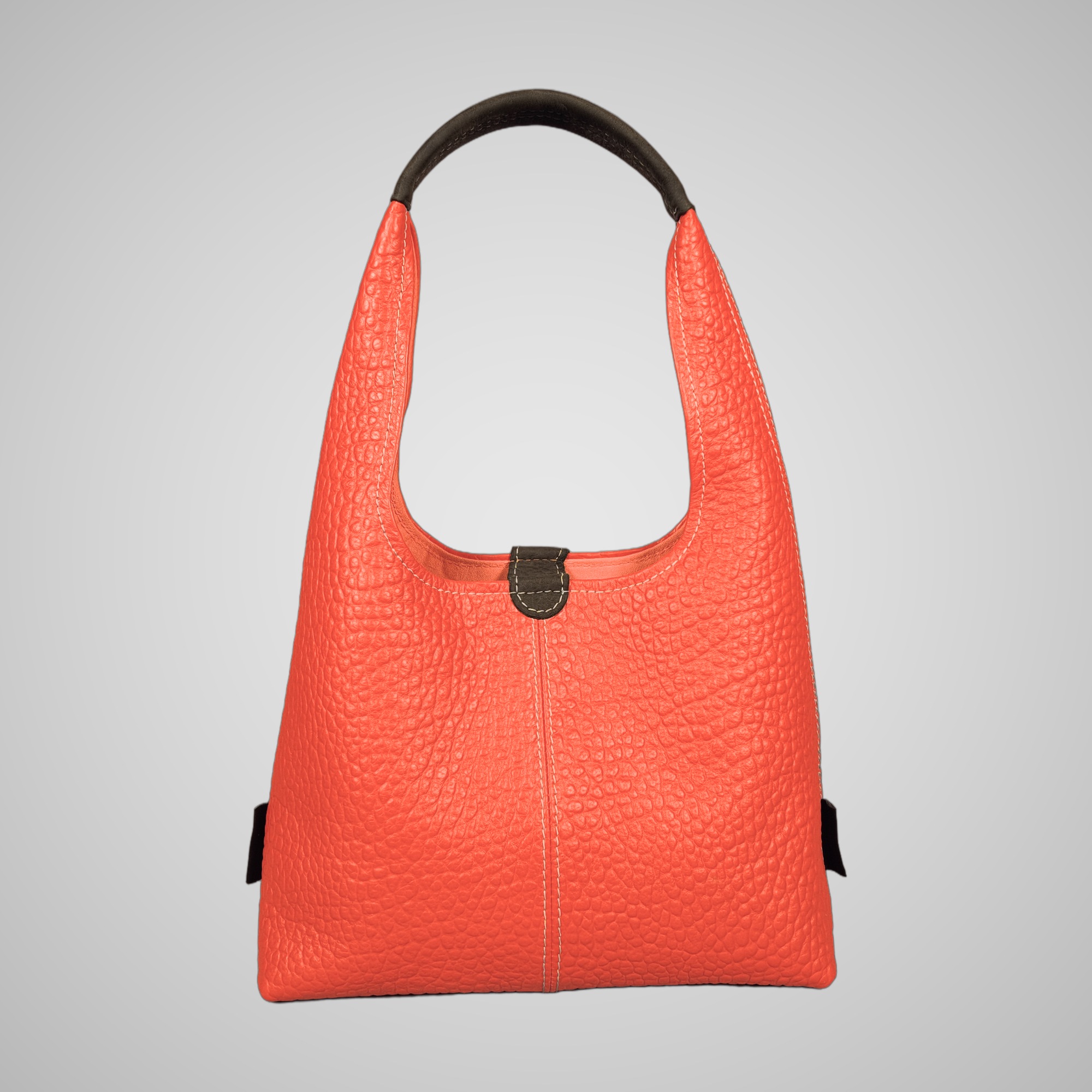 Back view of Lumengin Bubble Orange medium hobo bag in bright orange pebbled leather with dark grey handle, on soft grey