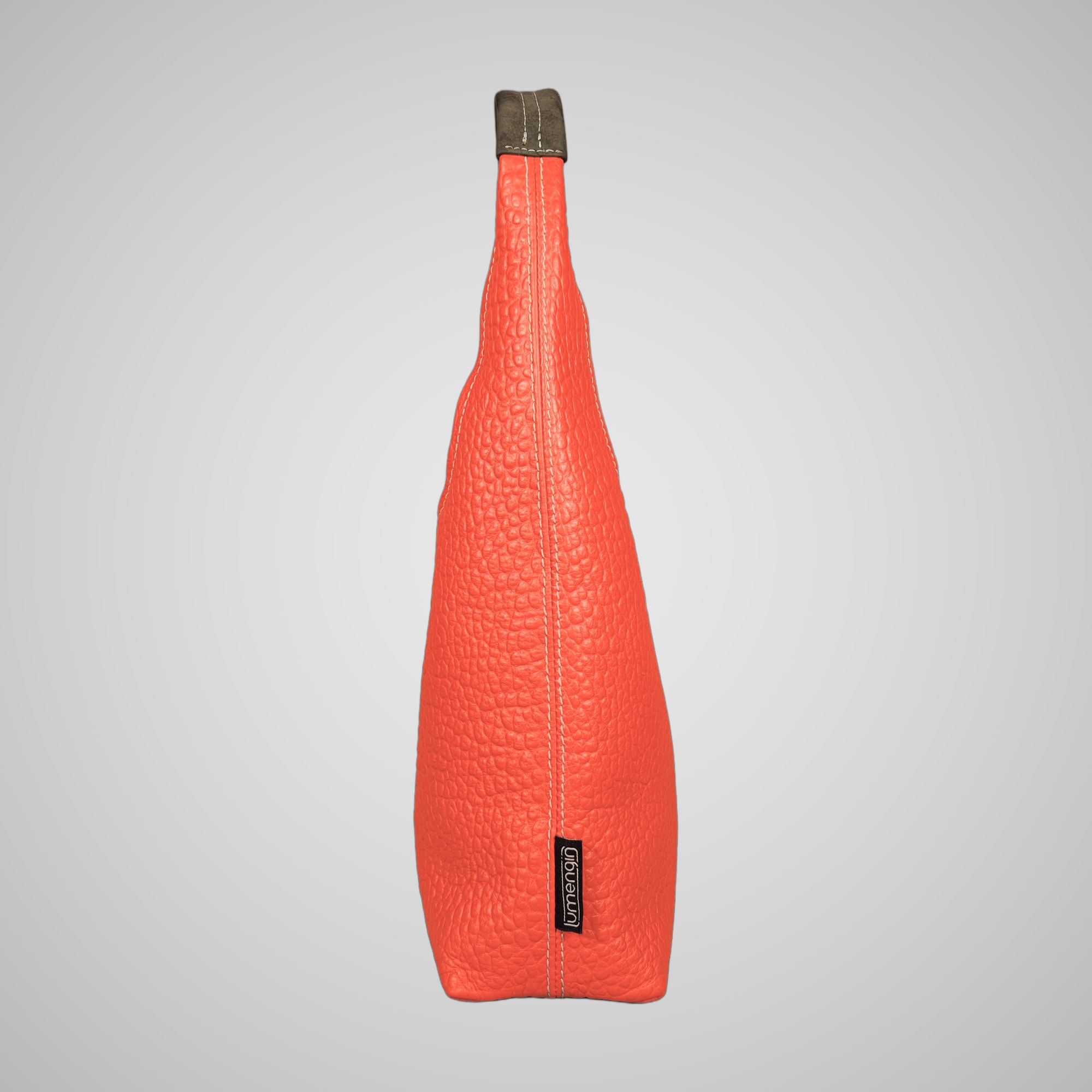 Side view of Lumengin Bubble Orange medium hobo bag in bright orange pebbled leather with Lumengin label on the side seam, on soft grey