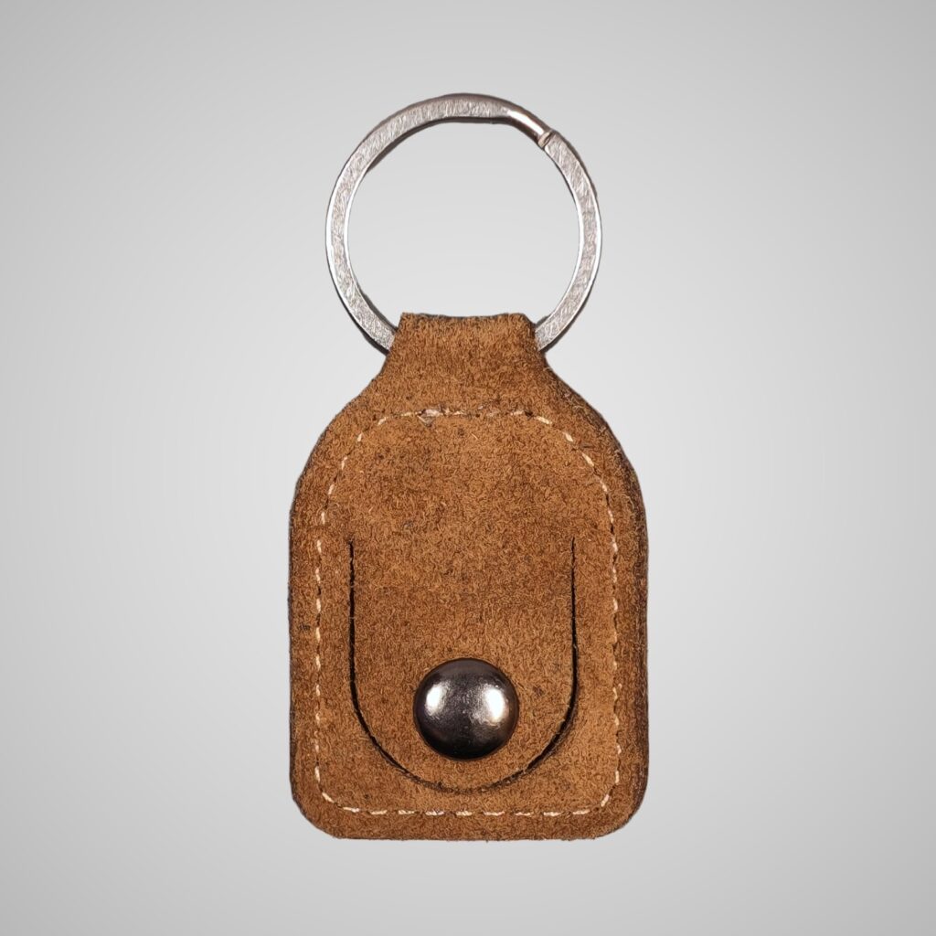 Lumengin gold calf suede £1 coin holder keyring, front view on soft grey background