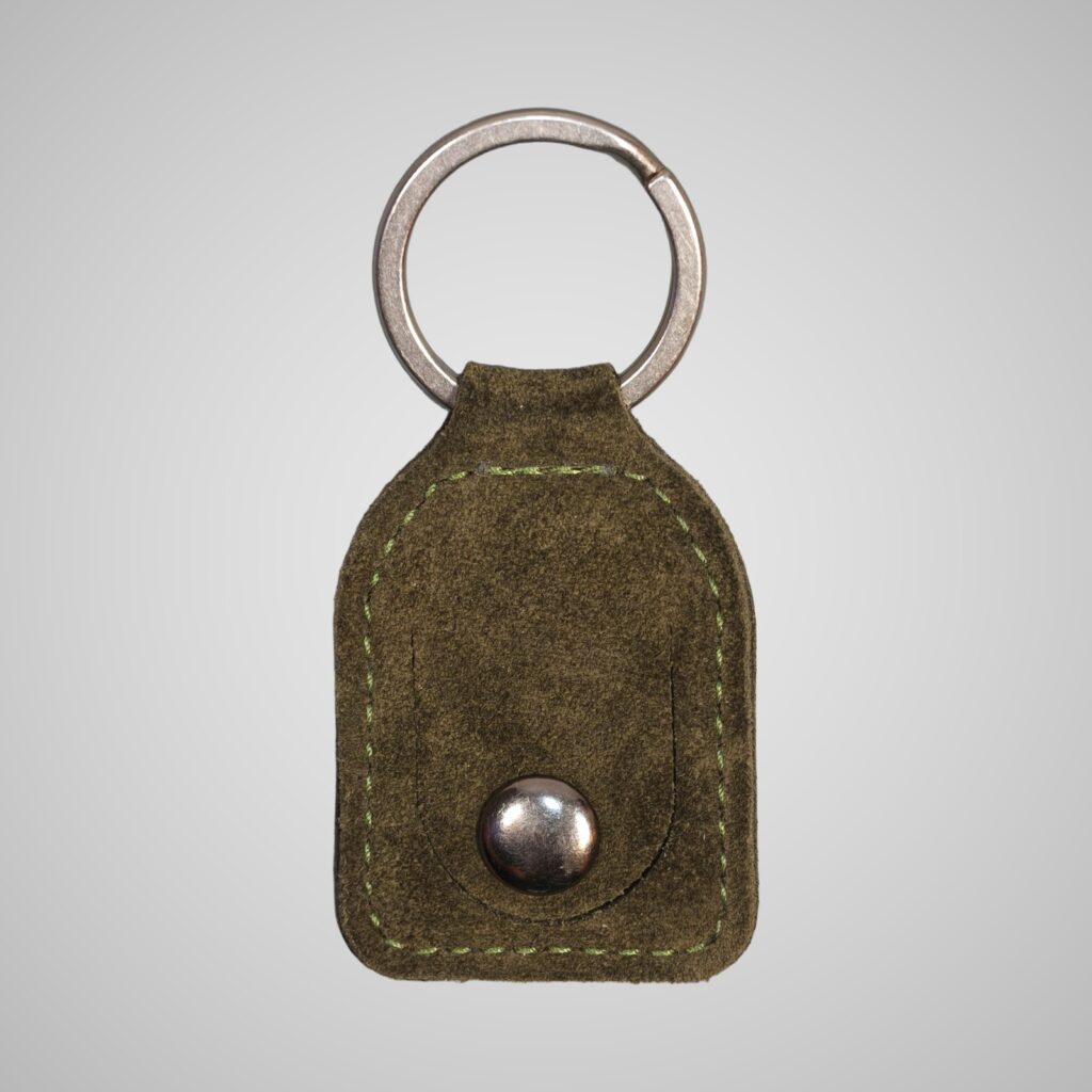 Lumengin green calf suede £1 coin holder keyring, front view on soft grey background