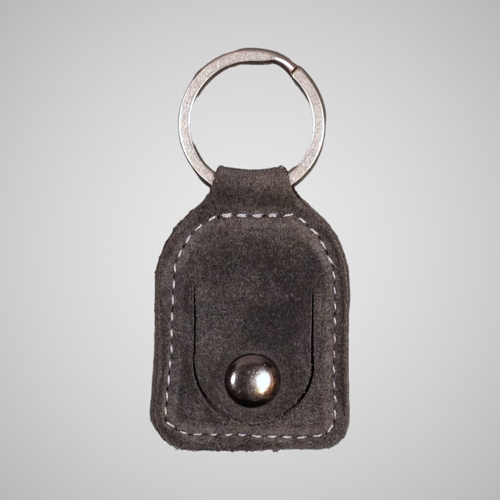 Lumengin grey calf suede £1 coin holder keyring, front view on soft grey background