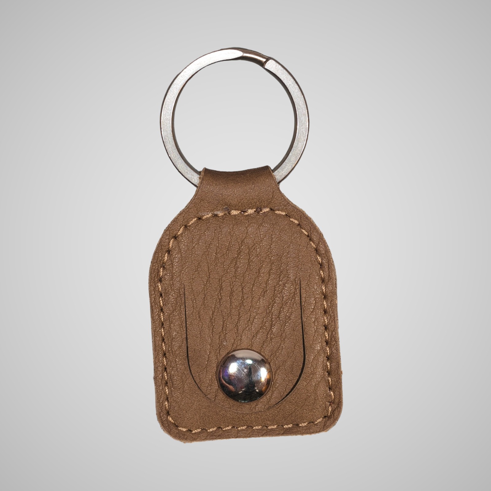 Lumengin green/gold Janus calf £1 coin holder keyring, front view on soft grey background