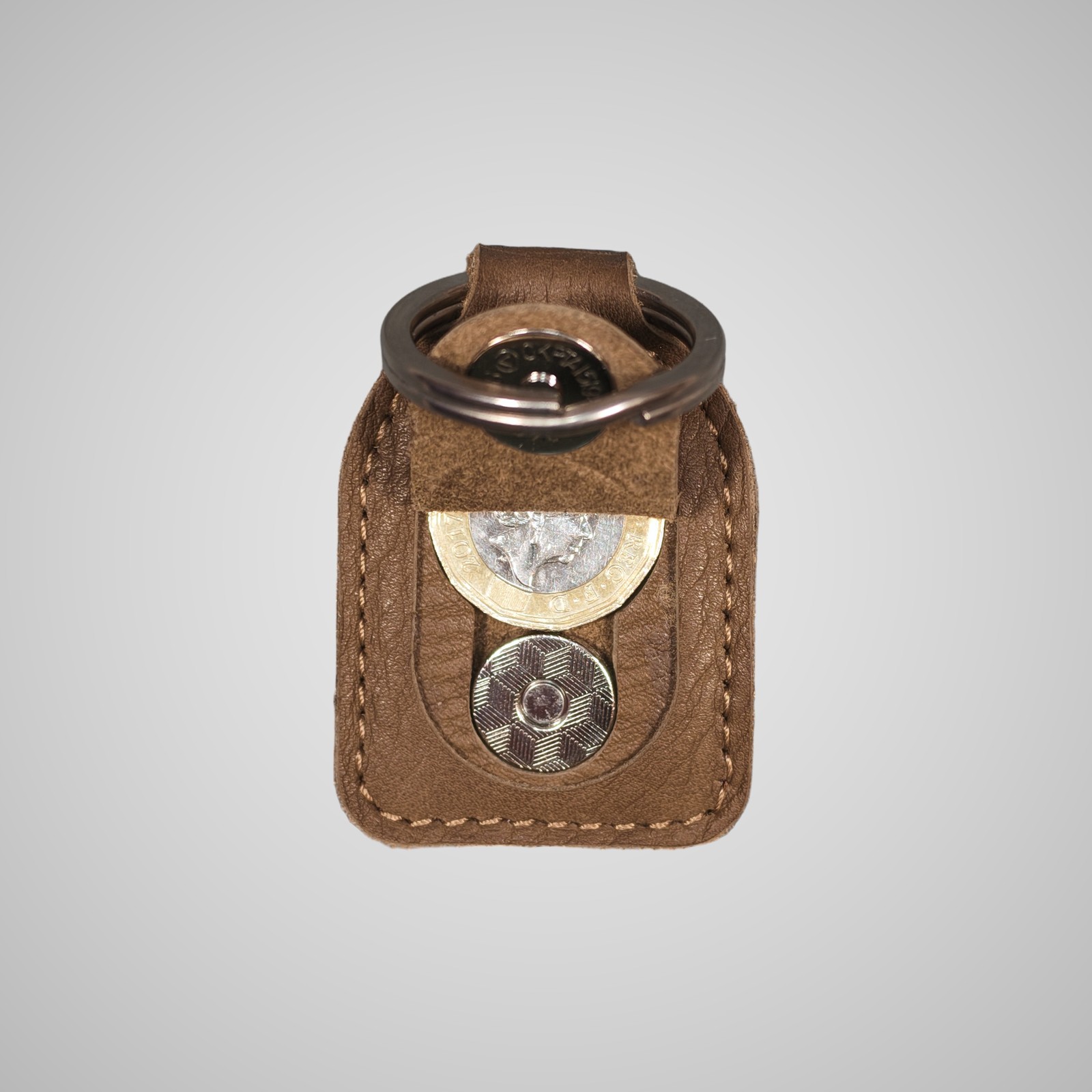Lumengin green/gold Janus calf £1 coin holder keyring, opened, holding a £1 coin, on soft grey background