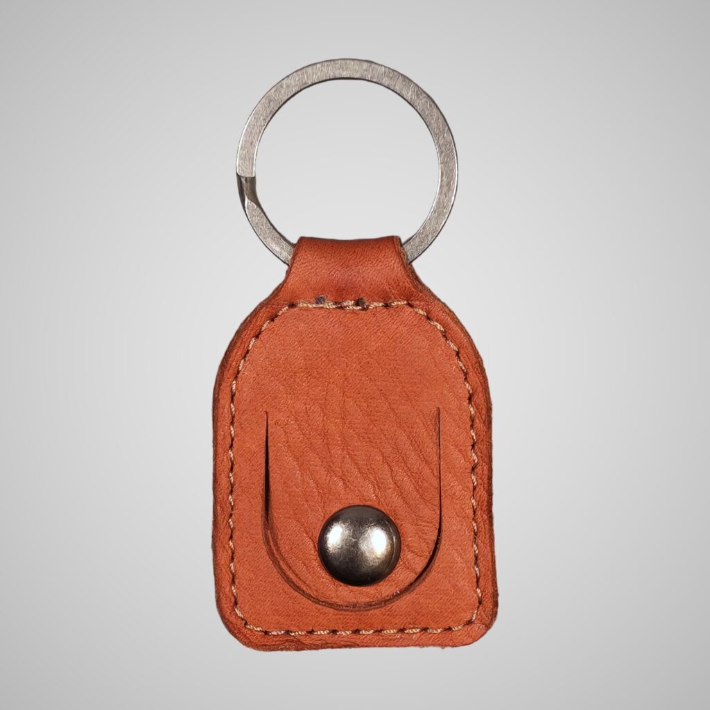 Lumengin light brown Janus calf £1 coin holder keyring, front view on soft grey background