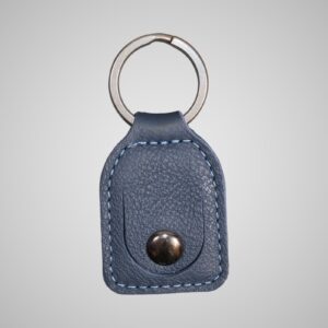 Lumengin marine blue-grey leather £1 coin holder keyring, front view on soft grey background
