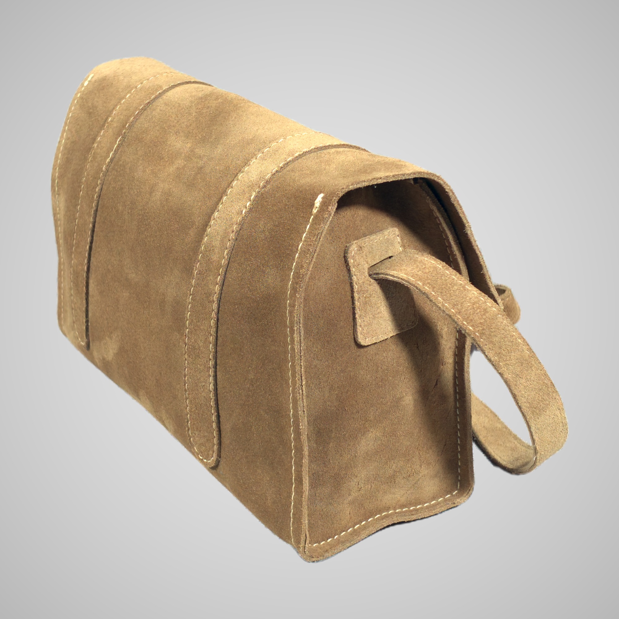 Side view of the Lumengin Sand calf suede cross-body bag, showing the gusset and strap fixing, on soft grey